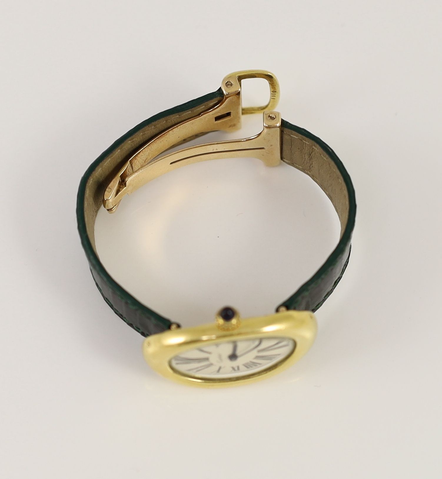 A lady's 18ct gold Cartier Baignoire manual wind oval wrist watch, on a Cartier green leather strap with deployment clasp